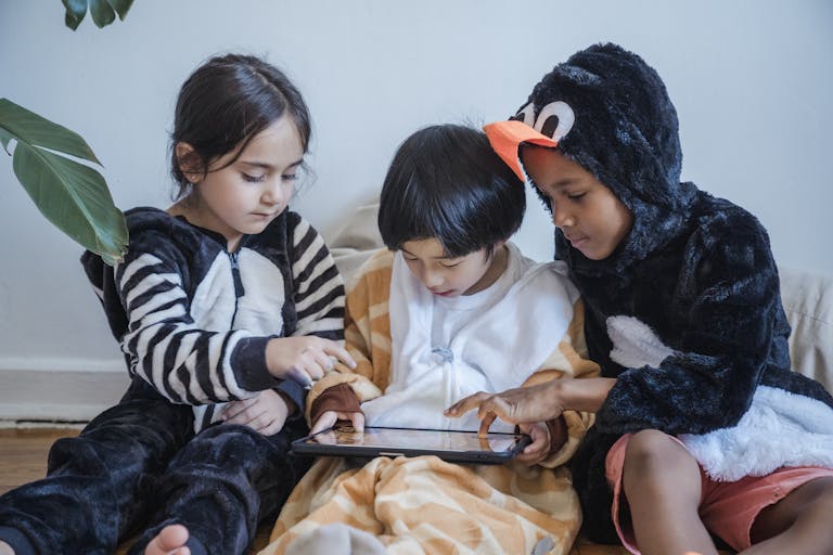 Kids in Costumes Playing Games with Tablet Computer