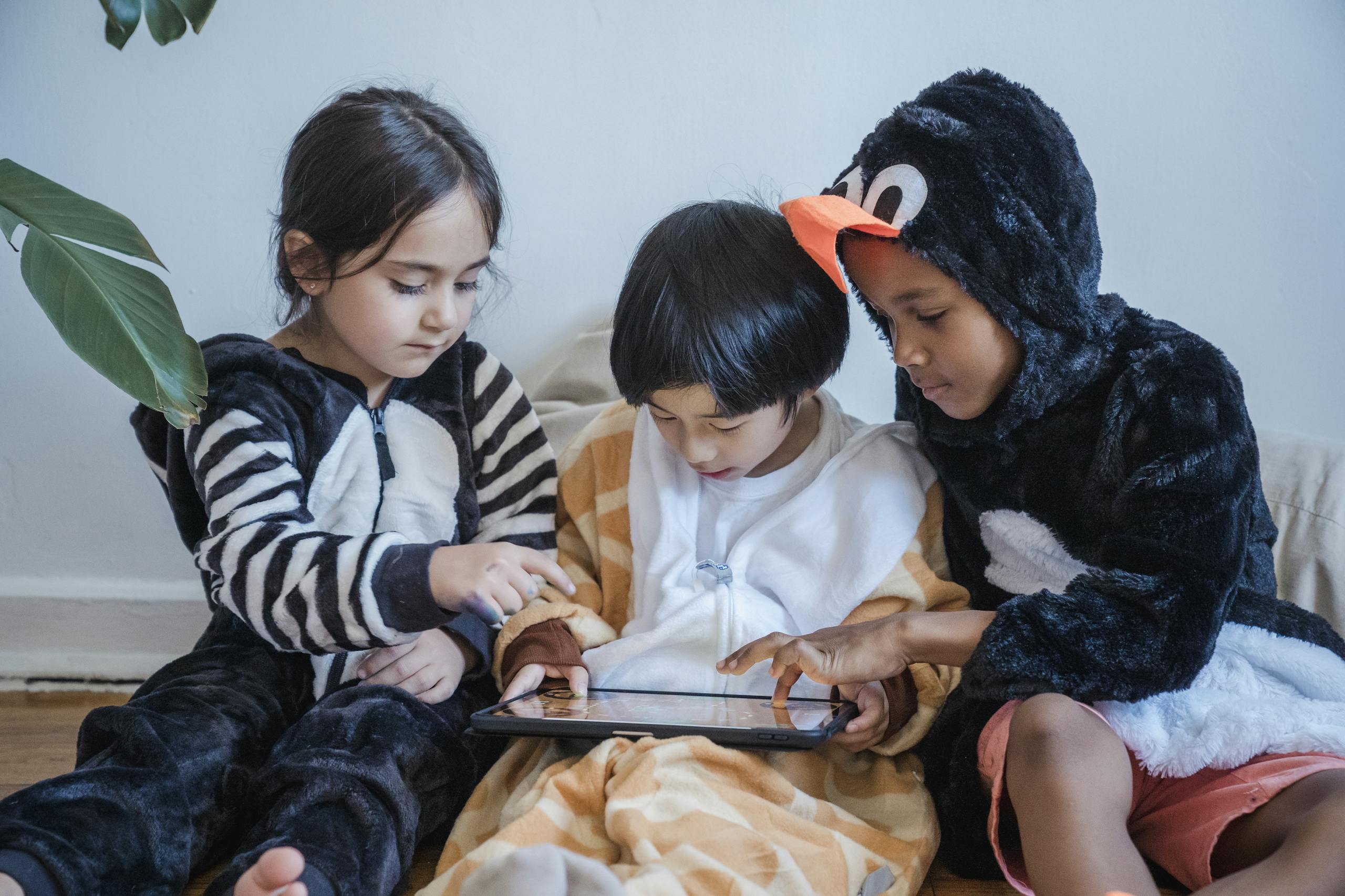 Kids in Costumes Playing Games with Tablet Computer